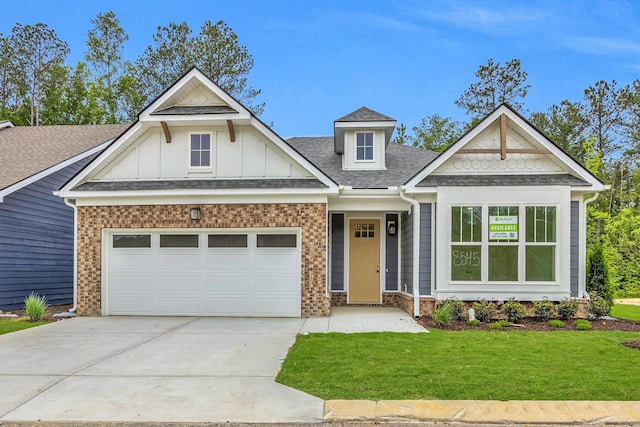 8545 Ari Ln, Chattanooga, TN 37421 - view of front of home with a front lawn, concrete driveway, roof with shingles, an attached garage, and board and batten siding