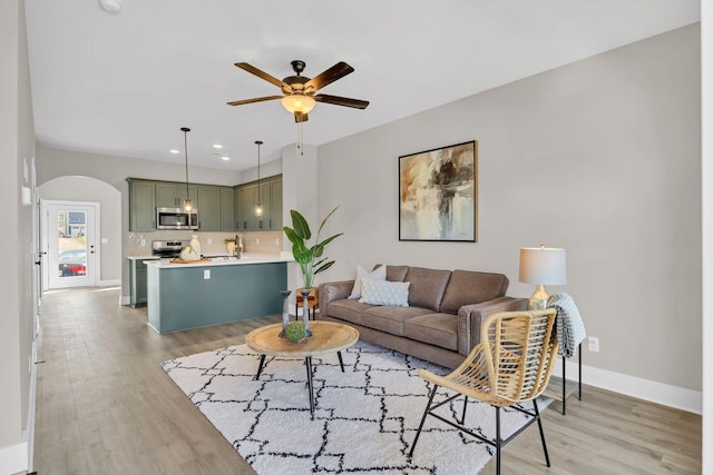 2413 E 17th St, Chattanooga, TN 37404 - living room with a ceiling fan, light wood finished floors, arched walkways, recessed lighting, and baseboards