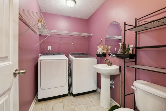 1217 Merritt Hill Trl, Smyrna, TN 37167 - laundry room with washer and dryer, baseboards, and a textured ceiling