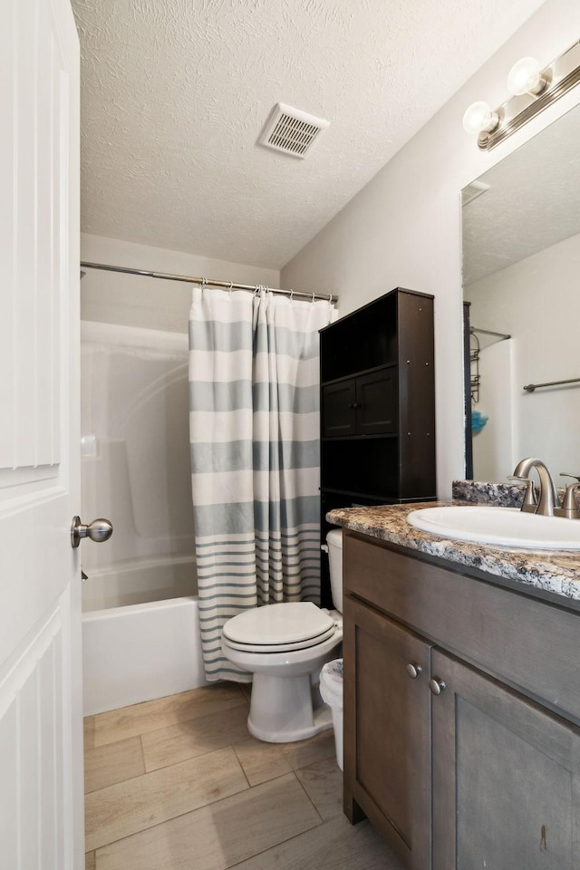 1217 Merritt Hill Trl, Smyrna, TN 37167 - bathroom featuring toilet, vanity, shower / bath combo with shower curtain, and a textured ceiling