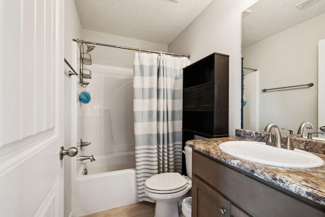 1217 Merritt Hill Trl, Smyrna, TN 37167 - bathroom with vanity, toilet, shower / tub combo with curtain, a textured ceiling, and wood finished floors