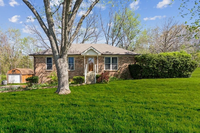 1190 Corum Hill Rd, Castalian Springs, TN 37031 - view of front of home featuring a front yard, brick siding, and an outdoor structure