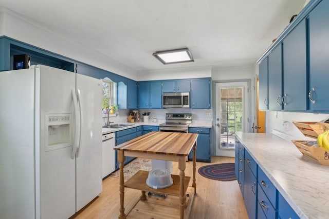 1190 Corum Hill Rd, Castalian Springs, TN 37031 - kitchen featuring appliances with stainless steel finishes, blue cabinetry, a sink, and light wood-style floors