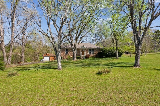 1190 Corum Hill Rd, Castalian Springs, TN 37031 - view of green lawn featuring a garage