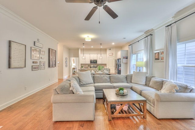 3433 Cortona Way, Murfreesboro, TN 37129 - living room featuring a ceiling fan, ornamental molding, light wood finished floors, and baseboards