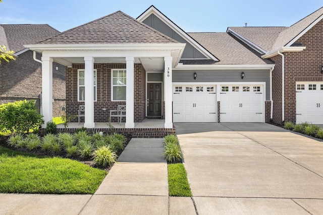 380 Gingerwood Ln, Hendersonville, TN 37075 - view of front facade with a porch, brick siding, a garage, and driveway