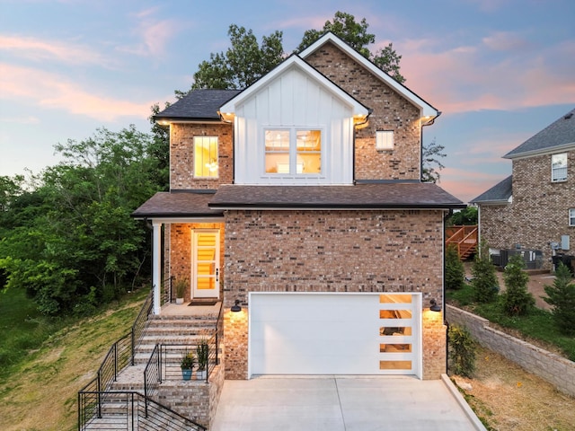 608 Summerbreeze Ln, Antioch, TN 37013 - view of front of property with an attached garage, board and batten siding, concrete driveway, and brick siding
