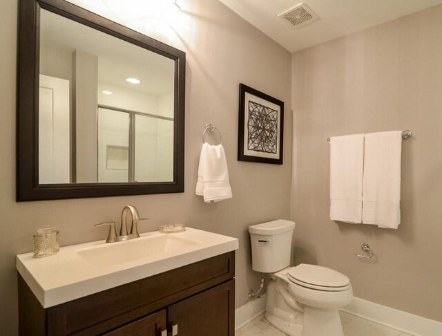 2507 Clifton Ave Unit 104, Nashville, TN 37209 - full bath with baseboards, toilet, vanity, marble finish floors, and a shower with door