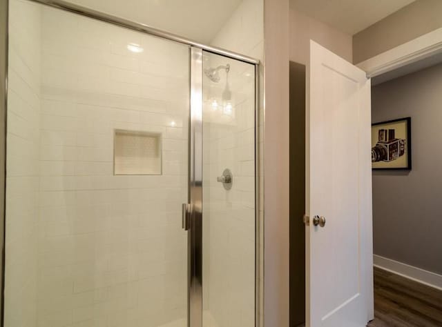 2507 Clifton Ave Unit 104, Nashville, TN 37209 - full bath with a shower stall, baseboards, and wood finished floors