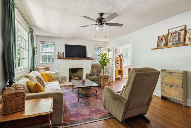 305 Andrews Ave, Hartsville, TN 37074 - living room with ceiling fan, a fireplace, wood finished floors, and a textured ceiling