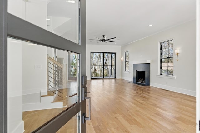 329 Lawndale Dr, Nashville, TN 37217 - unfurnished living room featuring a ceiling fan, a fireplace, stairs, light wood-type flooring, and baseboards