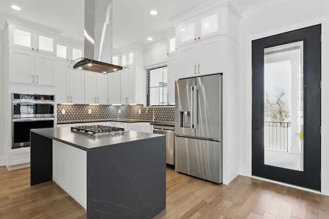 329 Lawndale Dr, Nashville, TN 37217 - kitchen with appliances with stainless steel finishes, island range hood, backsplash, a center island, and white cabinets