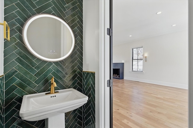 329 Lawndale Dr, Nashville, TN 37217 - bathroom with tile walls, a sink, wood finished floors, and a fireplace