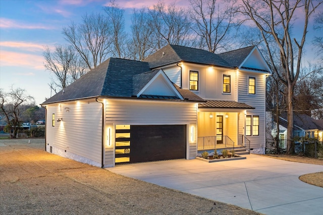 329 Lawndale Dr, Nashville, TN 37217 - view of front of house featuring concrete driveway, roof with shingles, a standing seam roof, metal roof, and a garage