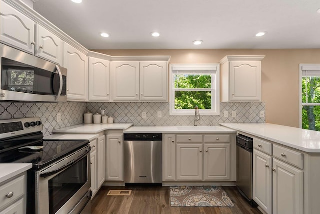 1056 Gilmore Hill Rd, Lebanon, TN 37087 - kitchen with stainless steel appliances, a peninsula, a sink, dark wood-type flooring, and white cabinets
