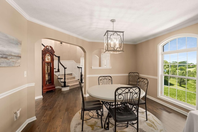 1056 Gilmore Hill Rd, Lebanon, TN 37087 - dining room featuring arched walkways, dark wood-style floors, a chandelier, baseboards, and crown molding