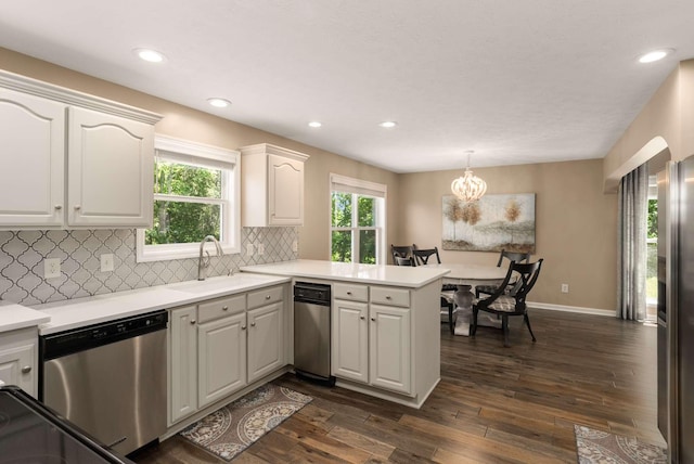 1056 Gilmore Hill Rd, Lebanon, TN 37087 - kitchen featuring stainless steel appliances, a peninsula, dark wood-style flooring, tasteful backsplash, and white cabinets