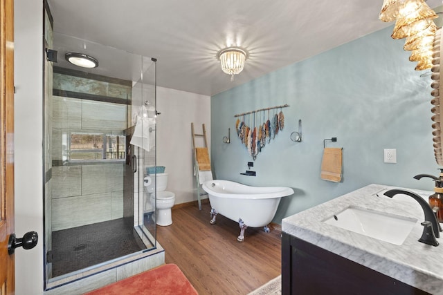 10669 S Windrow Rd, Rockvale, TN 37153 - full bathroom featuring a stall shower, wood finished floors, double vanity, a freestanding bath, and toilet