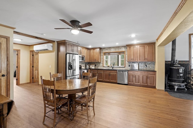 10669 S Windrow Rd, Rockvale, TN 37153 - dining room with a wood stove, a wall mounted AC, light wood-style floors, a ceiling fan, and ornamental molding