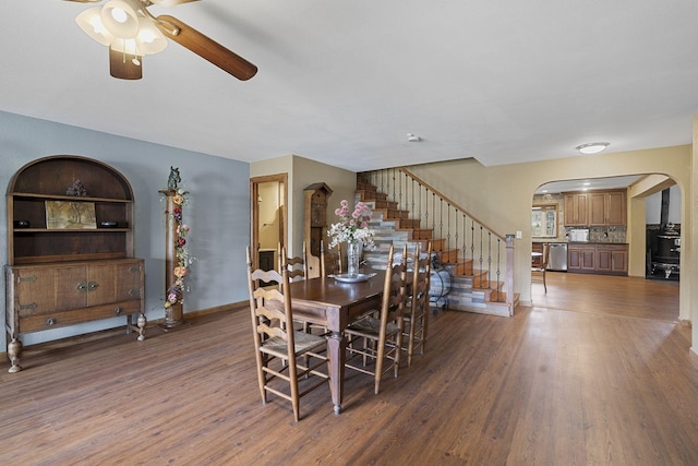 10669 S Windrow Rd, Rockvale, TN 37153 - dining area featuring arched walkways, ceiling fan, wood finished floors, and stairway