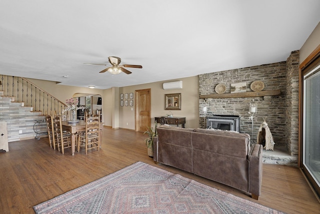 10669 S Windrow Rd, Rockvale, TN 37153 - living room featuring a wall unit AC, a ceiling fan, wood finished floors, and arched walkways