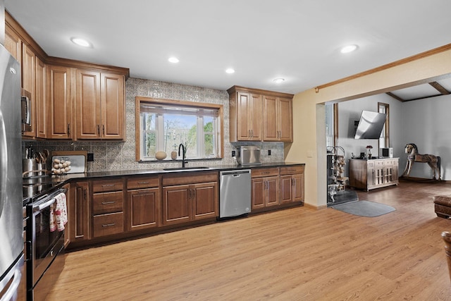 10669 S Windrow Rd, Rockvale, TN 37153 - kitchen featuring appliances with stainless steel finishes, a sink, dark countertops, tasteful backsplash, and light wood finished floors