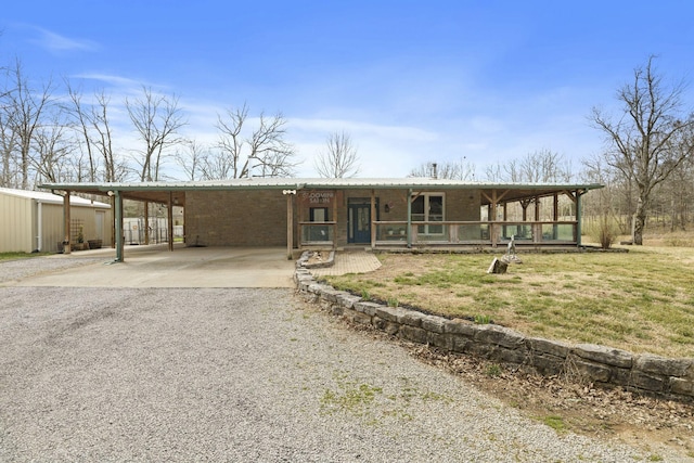 10669 S Windrow Rd, Rockvale, TN 37153 - view of front of home with driveway, a porch, a carport, brick siding, and metal roof