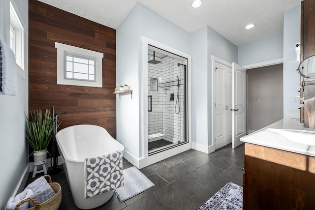 11 Walnut Creek Dr, Manchester, TN 37355 - bathroom featuring wooden walls, a stall shower, vanity, baseboards, and a soaking tub