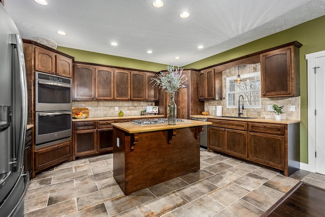 11 Walnut Creek Dr, Manchester, TN 37355 - kitchen with appliances with stainless steel finishes, a sink, recessed lighting, backsplash, and a center island