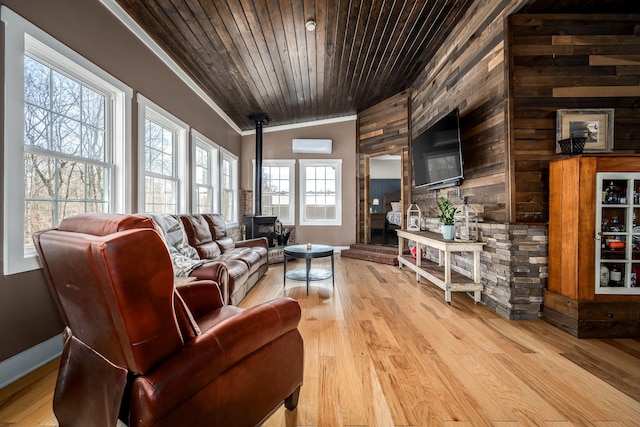 11 Walnut Creek Dr, Manchester, TN 37355 - living room with a wood stove, crown molding, an AC wall unit, wood walls, and light wood-style flooring
