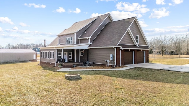 11 Walnut Creek Dr, Manchester, TN 37355 - view of front of house with an outdoor fire pit, concrete driveway, a front lawn, a garage, and roof with shingles