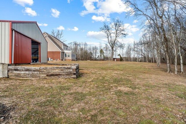 11 Walnut Creek Dr, Manchester, TN 37355 - view of green lawn featuring an outdoor structure and a pole building
