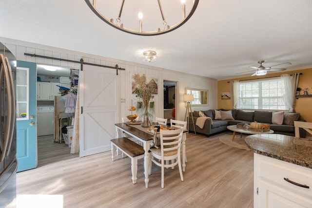 5935 Old Stage Rd, Huntingdon, TN 38344 - dining space featuring washer / dryer, a barn door, light wood-style floors, ceiling fan, and crown molding