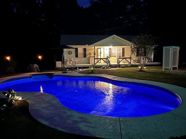 5935 Old Stage Rd, Huntingdon, TN 38344 - pool at night featuring an outdoor pool and a patio area