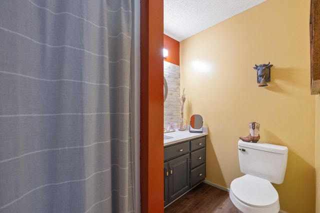 5935 Old Stage Rd, Huntingdon, TN 38344 - bathroom featuring wood finished floors, toilet, vanity, baseboards, and curtained shower