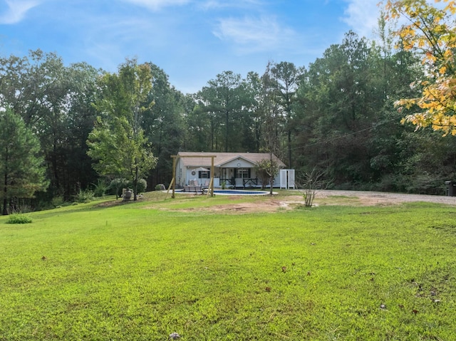 5935 Old Stage Rd, Huntingdon, TN 38344 - view of grassy yard featuring a swimming pool and a view of trees