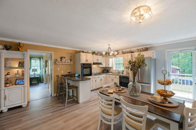 5935 Old Stage Rd, Huntingdon, TN 38344 - kitchen with black oven, a sink, dishwashing machine, a chandelier, and a textured ceiling