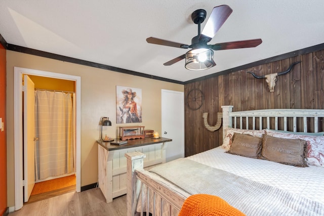 5935 Old Stage Rd, Huntingdon, TN 38344 - bedroom featuring light wood-style floors, ornamental molding, wood walls, and a ceiling fan