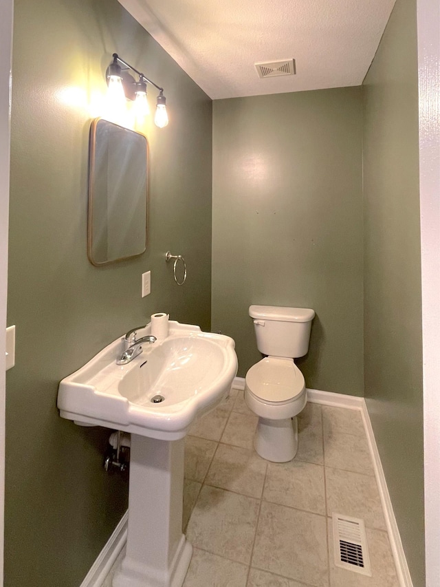 730 Everville Dr, Livingston, TN 38570 - bathroom with toilet, tile patterned flooring, baseboards, and a textured ceiling