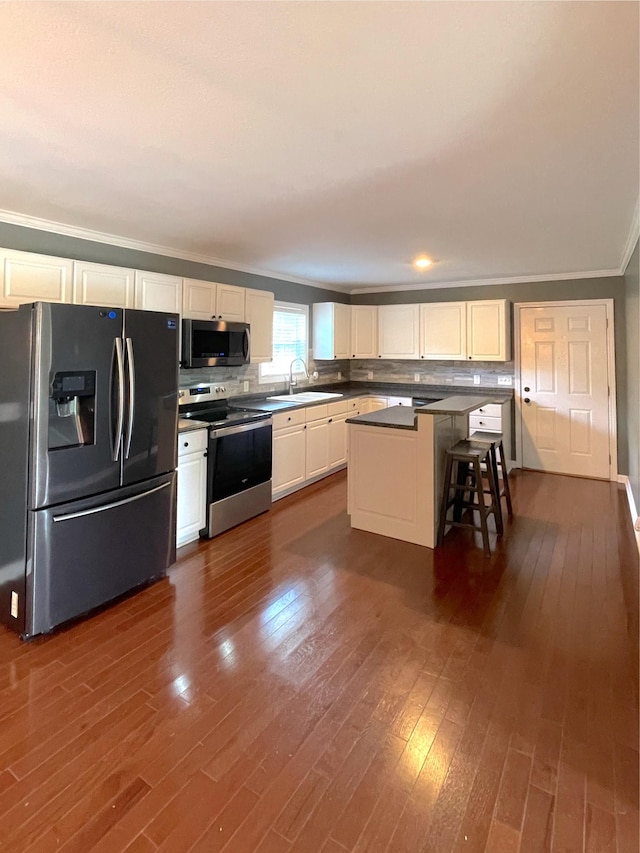 730 Everville Dr, Livingston, TN 38570 - kitchen featuring stainless steel appliances, ornamental molding, dark wood-style floors, and white cabinetry
