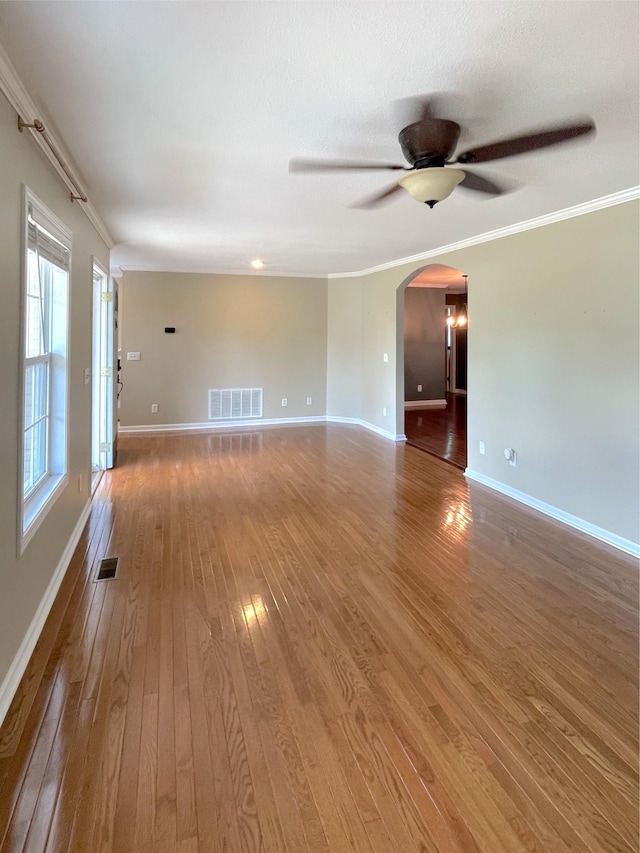 730 Everville Dr, Livingston, TN 38570 - spare room featuring arched walkways, a ceiling fan, hardwood / wood-style floors, baseboards, and crown molding