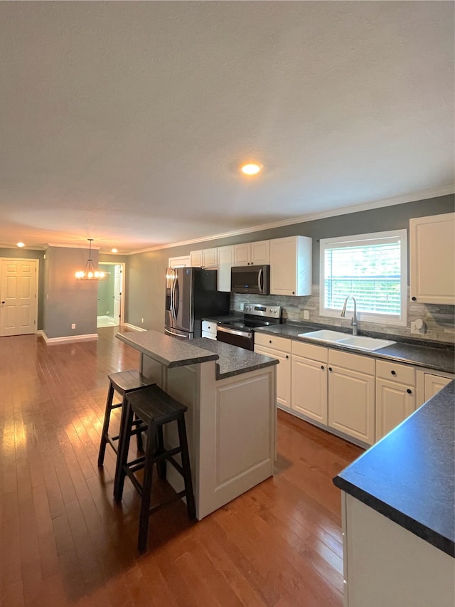 730 Everville Dr, Livingston, TN 38570 - kitchen with appliances with stainless steel finishes, a sink, dark countertops, dark wood-style flooring, and crown molding