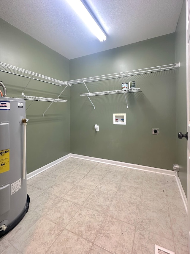 730 Everville Dr, Livingston, TN 38570 - laundry room with water heater, electric dryer hookup, washer hookup, a textured ceiling, and baseboards