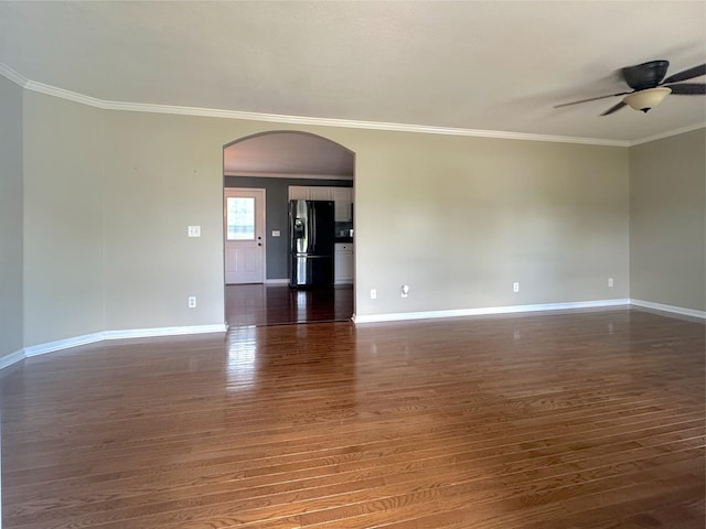 730 Everville Dr, Livingston, TN 38570 - spare room featuring arched walkways, a ceiling fan, wood finished floors, baseboards, and crown molding