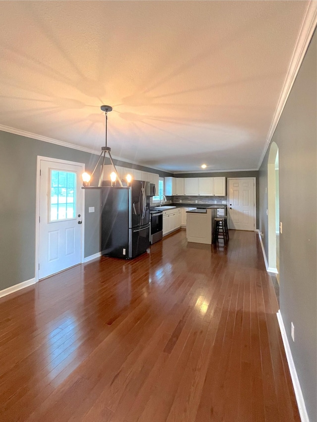 730 Everville Dr, Livingston, TN 38570 - kitchen with ornamental molding, dark wood-style floors, appliances with stainless steel finishes, white cabinetry, and a sink