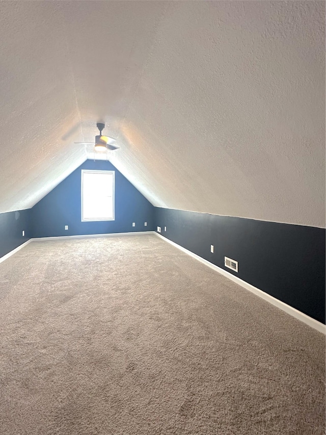 730 Everville Dr, Livingston, TN 38570 - additional living space with a textured ceiling, vaulted ceiling, baseboards, carpet, and a ceiling fan