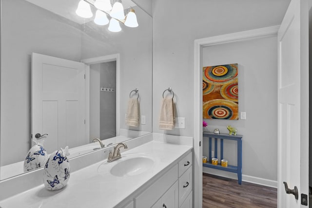 516 Main St, Burns, TN 37029 - bathroom featuring vanity, wood finished floors, a chandelier, and baseboards