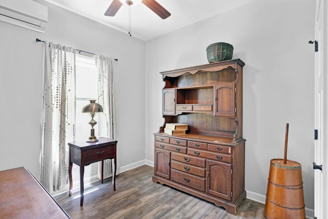 516 Main St, Burns, TN 37029 - home office featuring an AC wall unit, ceiling fan, light wood-style floors, and baseboards