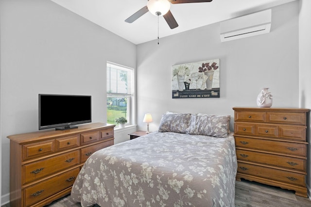 516 Main St, Burns, TN 37029 - bedroom with an AC wall unit, wood finished floors, and ceiling fan