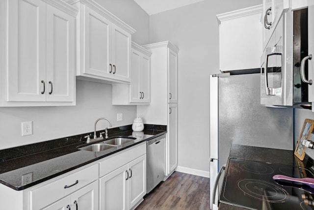 516 Main St, Burns, TN 37029 - kitchen featuring appliances with stainless steel finishes, a sink, white cabinets, baseboards, and dark stone counters